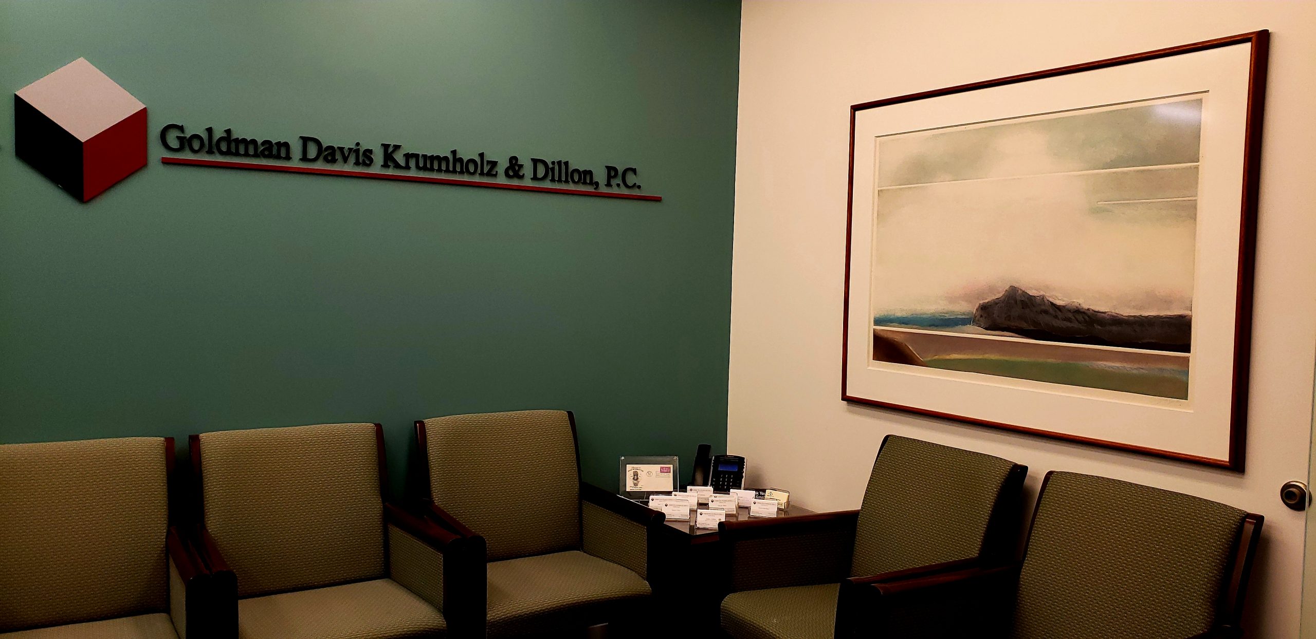 picture of a waiting room with green walls and gold chairs with a sign on the wall goldman davis krumholz & dillono