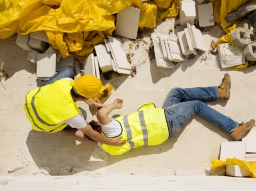 Workplace Accident picture of a construction worer laying on the ground hurt