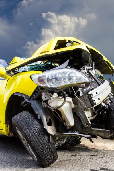 picture of a yellow car involved in a motor vehicle accident